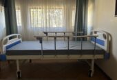 Two crank hospital bed in good condition for sale.