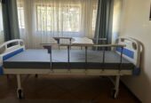 Two crank hospital bed in good condition for sale.